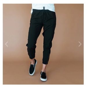 Albion Jettsetter joggers in black with gold zipper. Size small